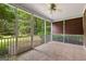 A screened porch with ceiling fan, tile floor and a view of the yard at 135 Horseshoe Cir, Fayetteville, GA 30215