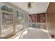 View of screened porch, featuring tile flooring, and views of mature trees at 135 Horseshoe Cir, Fayetteville, GA 30215