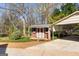 Cozy shed with a wood deck, complemented by a convenient carport and lush greenery at 135 Horseshoe Cir, Fayetteville, GA 30215