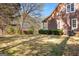 Home side yard featuring lush bushes and trees at 135 Horseshoe Cir, Fayetteville, GA 30215