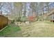 Landscaped backyard featuring a lawn, trees, and patio with seating area at 233 Creekstone Bnd, Peachtree City, GA 30269