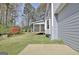 Exterior view of light gray home featuring screened porch and landscaped backyard at 233 Creekstone Bnd, Peachtree City, GA 30269