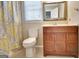 Bathroom with toilet, vanity with mirror, and shower featuring patterned curtain at 233 Creekstone Bnd, Peachtree City, GA 30269