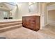 Carpeted bathroom featuring a vanity and a large bathtub with steps leading up at 233 Creekstone Bnd, Peachtree City, GA 30269