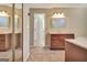 Bathroom boasts a wood vanity, large mirror, ample lighting, and an open doorway at 233 Creekstone Bnd, Peachtree City, GA 30269
