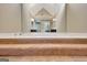 Carpeted steps lead to a bath tub set under a vaulted mirror with and sinks at 233 Creekstone Bnd, Peachtree City, GA 30269