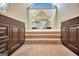 Bathroom with and vanities leading to a large bathtub with steps at 233 Creekstone Bnd, Peachtree City, GA 30269