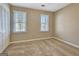Empty bedroom with neutral carpet, two windows with blinds, and white trim at 233 Creekstone Bnd, Peachtree City, GA 30269