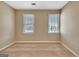 Neutral bedroom showcasing carpeted floors and two windows, providing ample natural light at 233 Creekstone Bnd, Peachtree City, GA 30269