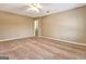 Spacious carpeted bedroom featuring ceiling fan and neutral color palette at 233 Creekstone Bnd, Peachtree City, GA 30269