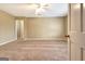 Large carpeted bedroom with a ceiling fan and view into the hallway at 233 Creekstone Bnd, Peachtree City, GA 30269