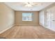 Bedroom featuring carpeted floors, a ceiling fan and a window at 233 Creekstone Bnd, Peachtree City, GA 30269