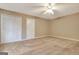 Carpeted bedroom featuring closet doors, ceiling fan, and natural light from the window at 233 Creekstone Bnd, Peachtree City, GA 30269