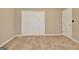 Neutral bedroom with carpeted floor, closet with bi-fold doors, and white trim at 233 Creekstone Bnd, Peachtree City, GA 30269