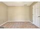 Empty carpeted bedroom featuring closet, white trim, and a window with bright natural light at 233 Creekstone Bnd, Peachtree City, GA 30269