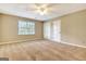Bedroom featuring carpeted floors, a ceiling fan and a window at 233 Creekstone Bnd, Peachtree City, GA 30269