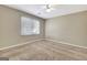 Empty bedroom with neutral walls, carpeted floor, ceiling fan, and a window with blinds at 233 Creekstone Bnd, Peachtree City, GA 30269