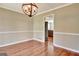 Dining room featuring classic millwork, hardwood floors and stylish lighting at 233 Creekstone Bnd, Peachtree City, GA 30269