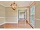 Open dining room featuring hardwood floors, modern lighting, and large windows at 233 Creekstone Bnd, Peachtree City, GA 30269