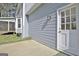 Exterior view of light gray home featuring white trim and door with modern outdoor light at 233 Creekstone Bnd, Peachtree City, GA 30269