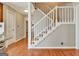 Entryway showcasing staircase with white banister and carpeted steps with view of the living room at 233 Creekstone Bnd, Peachtree City, GA 30269