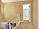 Upstairs hallway with carpeted floors and a view into a bedroom at 233 Creekstone Bnd, Peachtree City, GA 30269