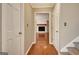 Hallway showcasing a glimpse into the living room, adorned with a charming fireplace at 233 Creekstone Bnd, Peachtree City, GA 30269