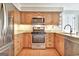 Modern kitchen featuring stainless steel appliances, granite countertops, and ample wooden cabinetry at 233 Creekstone Bnd, Peachtree City, GA 30269