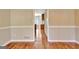 Kitchen with stainless steel appliances, hardwood floors, and a staircase nearby at 233 Creekstone Bnd, Peachtree City, GA 30269