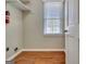 Bright laundry room with vinyl floors, white shelving, and window with natural light at 233 Creekstone Bnd, Peachtree City, GA 30269