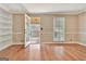 Living room featuring hardwood floors, built-in shelves, and access to a covered porch at 233 Creekstone Bnd, Peachtree City, GA 30269