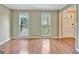 Inviting living room featuring hardwood floors and windows providing a view of the exterior at 233 Creekstone Bnd, Peachtree City, GA 30269