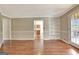 Spacious living room with hardwood floors, built-in shelving, and access to the outdoors at 233 Creekstone Bnd, Peachtree City, GA 30269