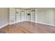 Corner view of living room, showcasing hardwood floors, and white built-in shelving at 233 Creekstone Bnd, Peachtree City, GA 30269