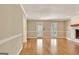 Bright living room with hardwood floors, fireplace, and natural light from the window at 233 Creekstone Bnd, Peachtree City, GA 30269