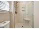 Tiled shower features glass doors, a built-in seat, and a shower head at 233 Creekstone Bnd, Peachtree City, GA 30269