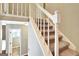 Carpeted staircase with white railing leading to the second floor of the home at 233 Creekstone Bnd, Peachtree City, GA 30269