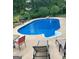 Inviting backyard pool with lounge chairs and tables, ideal for summer gatherings and outdoor entertainment at 233 Creekstone Bnd, Peachtree City, GA 30269
