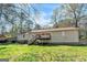 Spacious backyard features a wooden deck and lush greenery, perfect for outdoor gatherings at 104 Amberidge Nw Dr, Cartersville, GA 30121