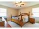 Bedroom with decorative ceiling fan, wood-framed bed, and carpeted floors at 104 Amberidge Nw Dr, Cartersville, GA 30121