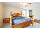Bedroom with decorative ceiling fan, wood-framed bed, and carpeted floors at 104 Amberidge Nw Dr, Cartersville, GA 30121