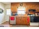 A classic kitchen with wooden cabinetry, a stainless steel dishwasher, and ample counter space at 104 Amberidge Nw Dr, Cartersville, GA 30121