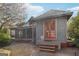 View of the home's backyard with a screened in patio with string lights, and access through french doors at 1009 Institute Nw St, Conyers, GA 30012