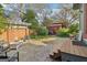 Serene backyard featuring a brick patio, outdoor seating, and mature trees and landscaping at 1009 Institute Nw St, Conyers, GA 30012