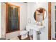 Bathroom featuring wood plank walls, white toilet and sink, rustic touches and green shutters at 1009 Institute Nw St, Conyers, GA 30012