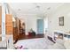 Bedroom featuring white plank walls, wood floors, a ceiling fan, with lots of toys and storage at 1009 Institute Nw St, Conyers, GA 30012