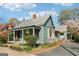 Charming home featuring a metal roof and inviting porch with beautiful, blooming landscaping and a brick pathway at 1009 Institute Nw St, Conyers, GA 30012