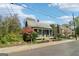 Charming home with a metal roof, inviting front porch, and vibrant landscaping, set on a tree-lined street at 1009 Institute Nw St, Conyers, GA 30012