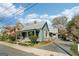 View of the charming cottage-style home with metal roof and inviting porch, showcasing its curb appeal at 1009 Institute Nw St, Conyers, GA 30012
