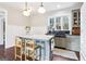 Bright kitchen featuring an island with seating, soapstone sink, and natural light from a large window at 1009 Institute Nw St, Conyers, GA 30012